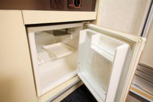 an empty refrigerator with its door open in a kitchen at Monthly Mansion Tokyo West 21 - Vacation STAY 10867 in Fuchu