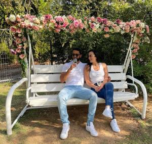 a man and a woman sitting on a white bench at Orhan Havaya in Sheʼar Yashuv