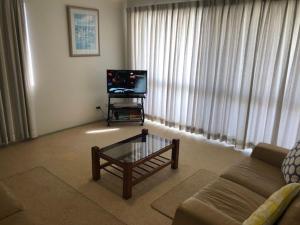 A television and/or entertainment center at Sorrento Seaside Holiday Apartments