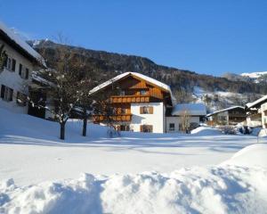 a building in a snow covered yard with snow at Ferienwohnung Habit in Schruns-Tschagguns +9 photos