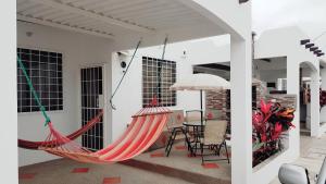 a patio with a hammock and a table and chairs at Riveri Salinas V53 in Salinas