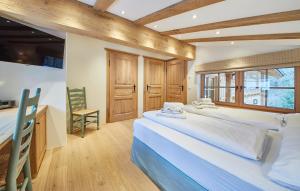 a large bedroom with two beds and a desk at Chalet Tannenbaum in Saalbach-Hinterglemm +61 photos