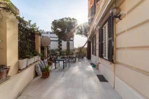 an empty courtyard of a building with tables and chairs at Domus Aurea B&B and Suites in Rome