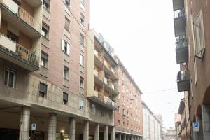 a row of tall buildings on a city street at Lame, Bologna by Short Holidays in Bologna