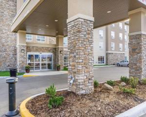 a front view of a building with a parking lot at Comfort Inn & Suites Edmonton International Airport in Nisku