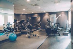 a gym with several treadmills and exercise bikes at Radisson Blu Waterfront Hotel, Stockholm in Stockholm