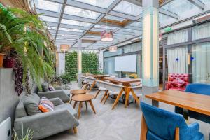 a living room with a table and chairs and a dining room at Best Western Tbilisi City Center in Tbilisi City