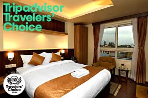 Ένα ή περισσότερα κρεβάτια σε δωμάτιο στο The Milestone Hotel