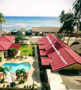 an aerial view of a resort with a swimming pool and the ocean at Aloha Seaside Resort in Siquijor