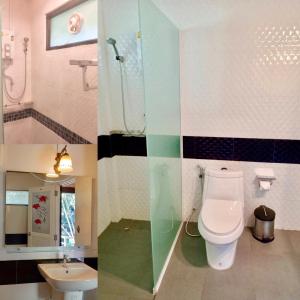 een badkamer met een toilet en een wastafel bij Khao Sok River Lodge Hotel in Khao Sok