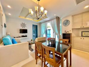 a dining room and living room with a dining table at Chelona huahin beachfront resort condo in Khao Tao