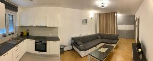 a kitchen and a living room with a couch at Apartman Bistrica in Livno