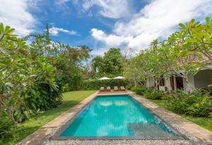 a swimming pool in the backyard of a villa at Nyne Hotels - Rock Villa, Bentota in Bentota