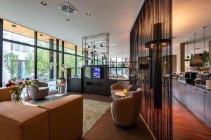 a lobby with couches and a table and a kitchen at Hotel Docklands in Antwerp