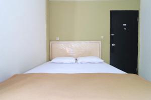 Voodi või voodid majutusasutuse AMS Hotel Koja toas