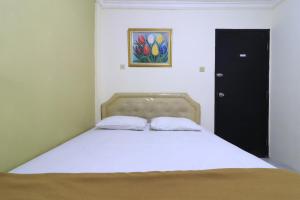Voodi või voodid majutusasutuse AMS Hotel Koja toas