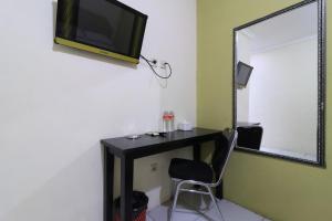 Televiisor ja/või meelelahutuskeskus majutusasutuses AMS Hotel Koja