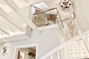 a staircase in a house with white walls and ceilings at HOME Suites Maisonette mit Sauna in Braunlage