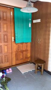 a room with a door and a table and a stool at すずめのお宿 つばめの間 最大30名 Swallow room Maximum of 30 people in Kotohira