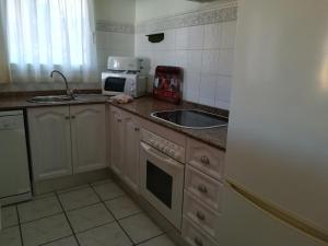 a kitchen with a sink and a microwave at 0309 Monteverde Nectar in Balcon del Mar