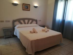 a bedroom with a bed with two pillows on it at 0309 Monteverde Nectar in Balcon del Mar +10 photos