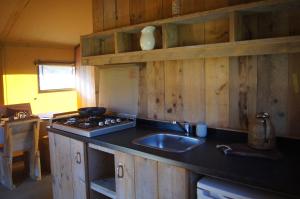 a kitchen with a sink and a stove at Hoeve Linnerveld XL in Sint Odiliënberg