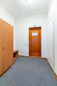 an empty room with a wooden door and a hallway at Гостиница Большой Урал in Yekaterinburg
