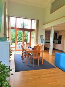 a kitchen and dining room with a table and chairs at Villa Ohaijo in Riga