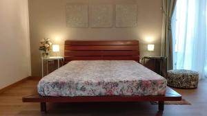 a bedroom with a large bed with a wooden headboard at Casa Montefinese1 in Casamassima