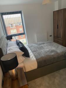 a bedroom with a bed and a large window at Icona - Stylish apartment in brand new development! in York