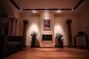 a living room with a fireplace and two pillars at Castello di Pandora in Nepi