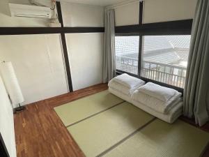 a living room with a couch and a large window at Hwadam Inn in Gunsan
