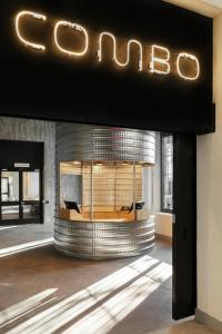 a lobby of a building with a sign that reads gucci at Combo Torino in Turin