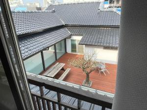 a balcony with a bench and a tree on a deck at Hwadam Inn in Gunsan-si