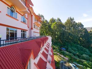 a view of a building with red roof at The Byke Sunshine Grand in Ooty