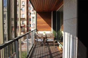 a balcony with a table and chairs on a building at Passeig de gracia sun apartament balcony 2 bedrooms in Barcelona