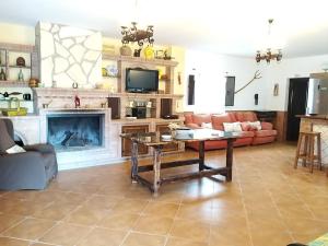a living room with a table and a fireplace at Benavilla in Albuñol