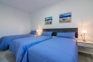 Posteľ alebo postele v izbe v ubytovaní Santa María FreshApartments