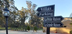 a street sign in a park next to a street light at Chez Vous French Cottage - Pokolbin Hunter Valley! in Pokolbin
