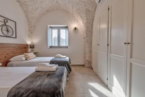 Postel nebo postele na pokoji v ubytování Trulli in Vigna