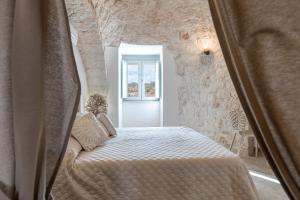 A bed or beds in a room at Trulli in Vigna