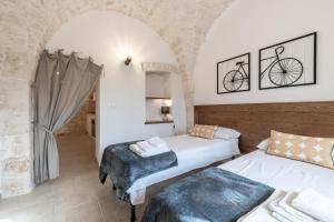 A bed or beds in a room at Trulli in Vigna