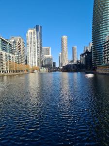 a large body of water in a city with tall buildings at Wns Hotel Canary Wharf in London