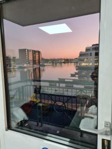 a view from a window of a boat in the water at Wns Hotel Canary Wharf in London