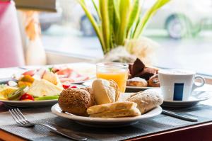 a table with plates of food and a cup of coffee at Áurea Casa Palacio Sagasta by Eurostars Hotel Company in Cádiz