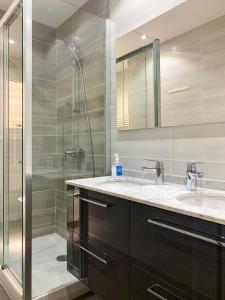 uma casa de banho com 2 lavatórios e um chuveiro em Apartamento Perfección al lado de Caldea em Escaldes-Engordany