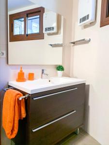 a bathroom with a sink and a mirror at Apartamento Font Blanca en Arinsal in Mas de Ribafeta