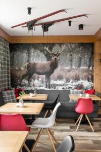 a restaurant with a deer mural on the wall at Willa Klimkówka in Zakopane