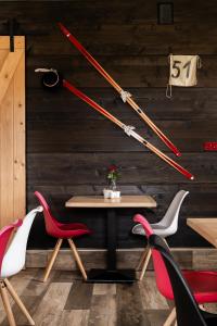 a table with two chairs and two baseball bats on a wall at Willa Klimkówka in Zakopane