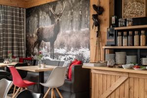 a restaurant with a deer painting on the wall at Willa Klimkówka in Zakopane